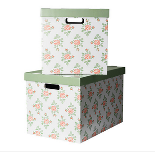 2 Cardboard boxes with flowers design stacked on top op each other