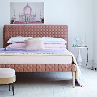 bedroom with white wall and peach pastel colour bed