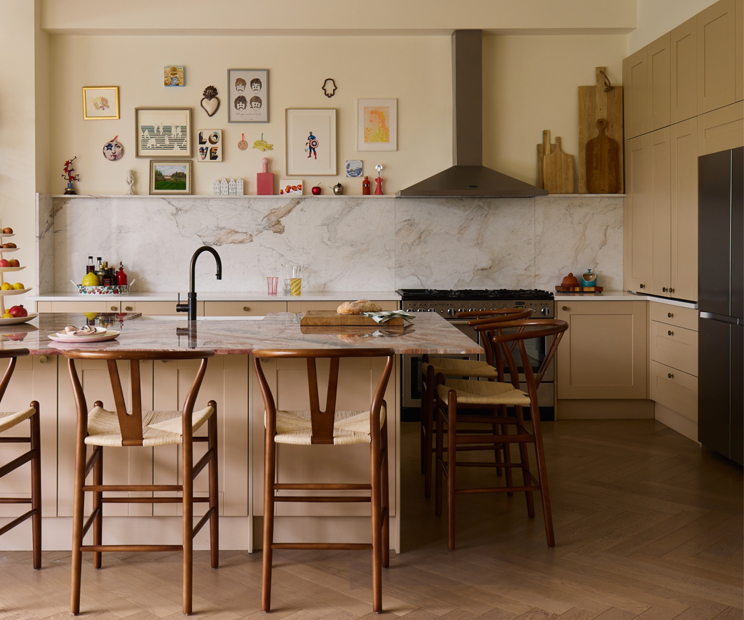 A neutral kitchen with shaker cabinets and marbole countertops