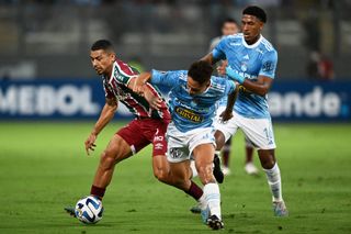 Fluminense's midfielder Andre Trindade (L) and Sporting Cristal's midfielder Jesus Pretell vie for the ball during the Copa Libertadores group stage first leg football match between Sporting Cristal and Fluminense, at the National stadium in Lima, on April 5, 2023.