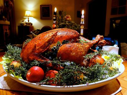 Plated Turkey Surrounded By Fruits Vegetables And Herbs