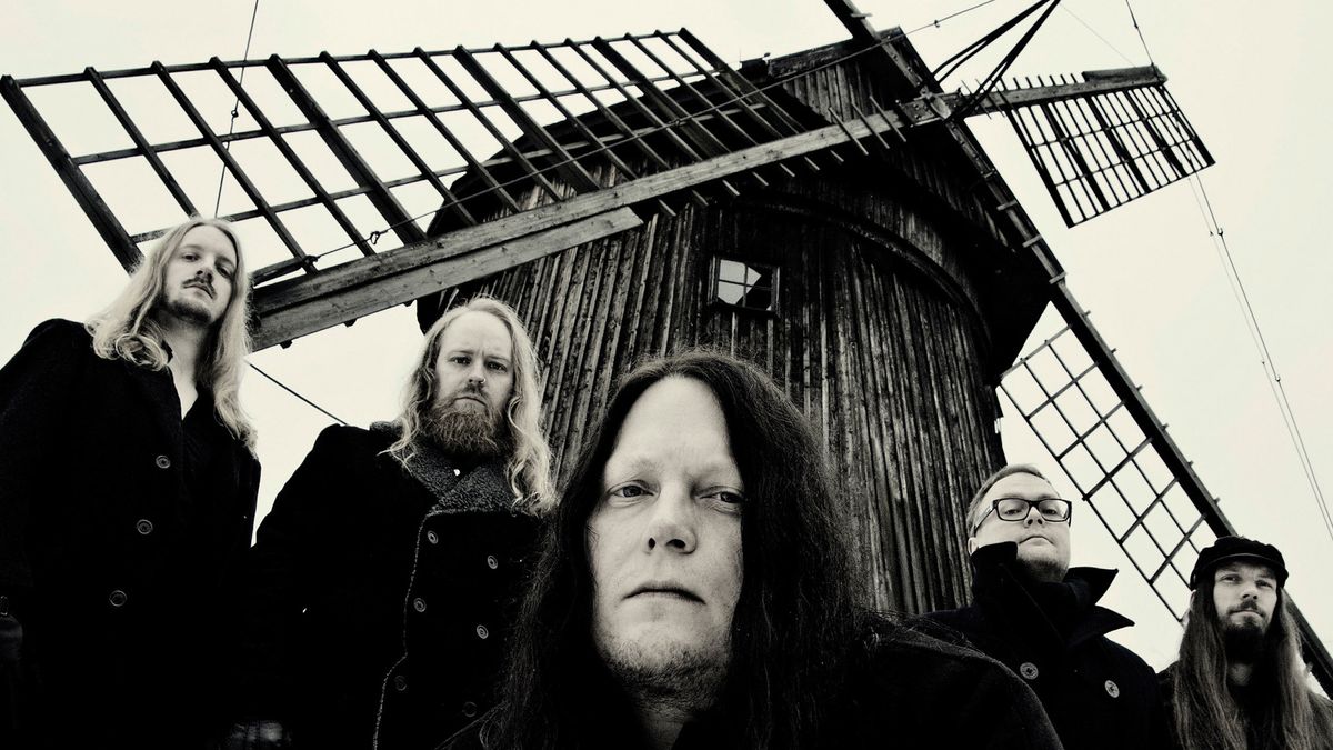 Katatonia standing by a windmill