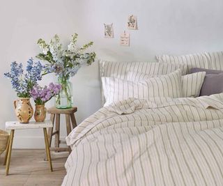 Pear Ticking Stripe Linen Pillowcases on a bed.