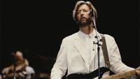 English guitarist Eric Clapton performs live on stage playing a black Fender Stratocaster guitar at Wembley Stadium in London in June 1992.