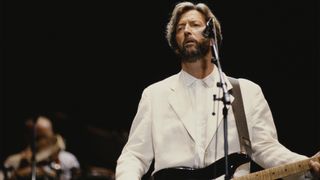 English guitarist Eric Clapton performs live on stage playing a black Fender Stratocaster guitar at Wembley Stadium in London in June 1992.