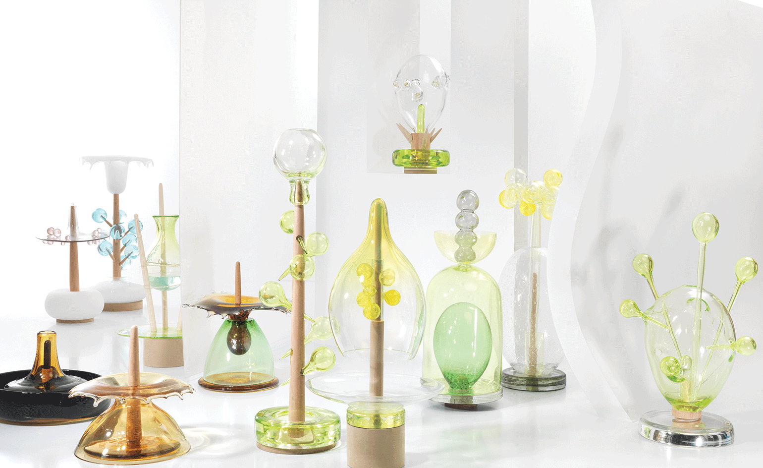 View of The Glass Calendar collection by Ruinart and Hubert le Gall featuring different colours and shapes pictured against a light coloured background