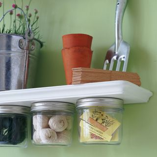 storage with underneath shelving and mason jars