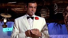 Sean Connery's James Bond looks at someone off camera in Goldfinger