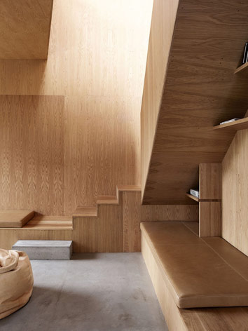 A detail of the living area. Steps lead to the floor above, below which there is a reading nook.