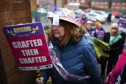 A Waspi campaigner holds a placard