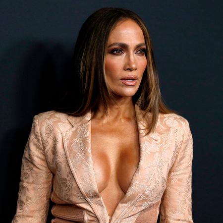 jennifer lopez takes a photo at a netflix red carpet event