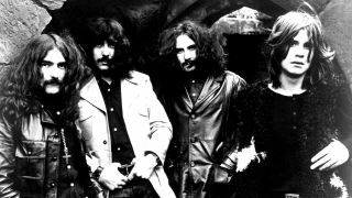 Black Sabbath posing for a photograph in a stone archway in 1970