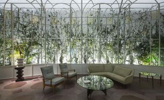 hedgerows, white-gated screens, white pebbles and tropical palms decorated the Tod's show space