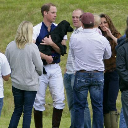 Prince William cuddling his dog 