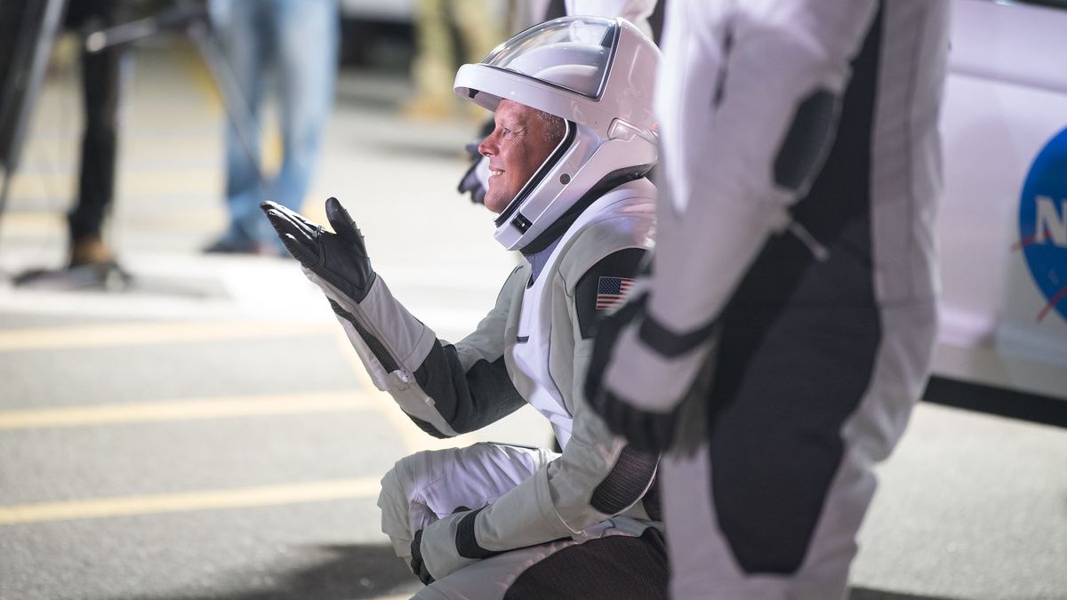 NASA astronaut Robert Hines gestures to family and friends as he and crew mates NASA astronauts Kjell Lindgren, Jessica Watkins, and ESA (European Space Agency) astronaut Samantha Cristoforetti, wearing SpaceX spacesuits, depart the Neil A. Armstrong Operations and Checkout Building for Launch Complex 39A to board the SpaceX Crew Dragon spacecraft for the Crew-4 mission launch, Tuesday, April 26, 2022, at NASA&rsquo;s Kennedy Space Center in Florida.