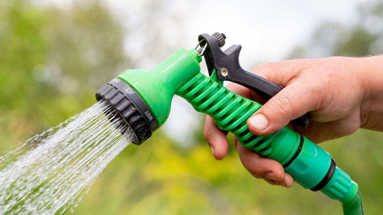 A green hose spray nozzle 