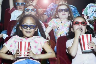 A group of children enjoying a movie at the cinema.