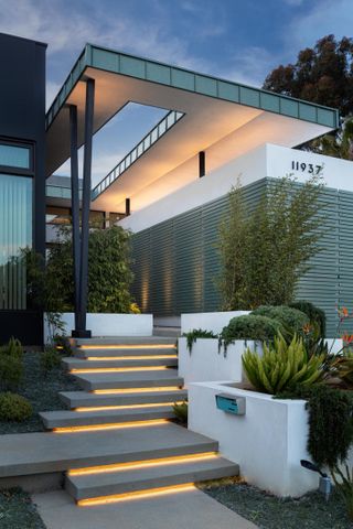 Dramatic night view of front entrance at Mar Vista Residence by Tim Gorter Architect