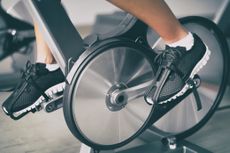 Peloton bike's wheels with a person's feet on the pedals