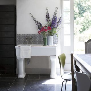 white sink with dining table and flower vases