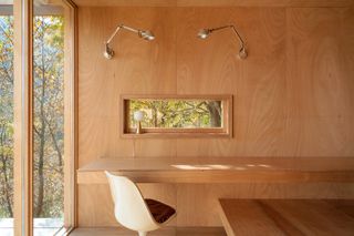 built in desk with Tulip chair inside a wood tiny house