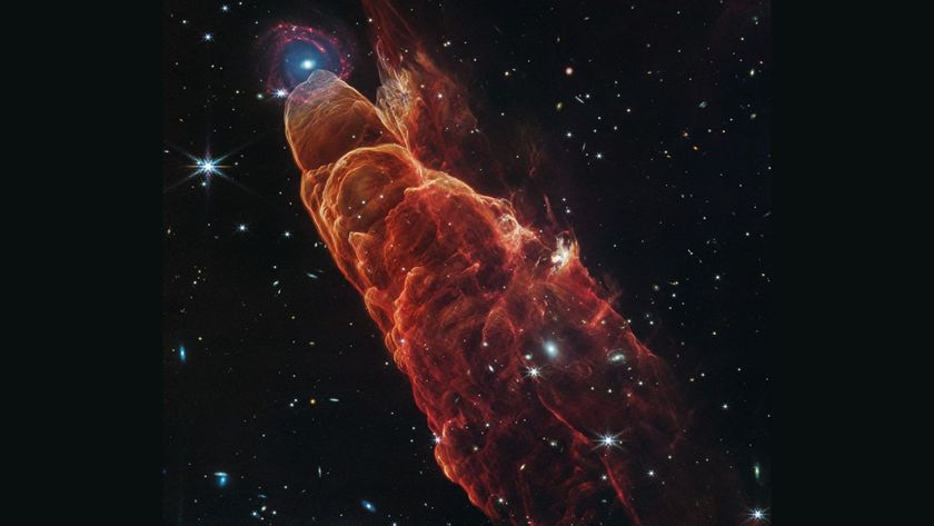 An image of a tornado-shaped glowing orange cloud in outer space with many bright twinkling stars