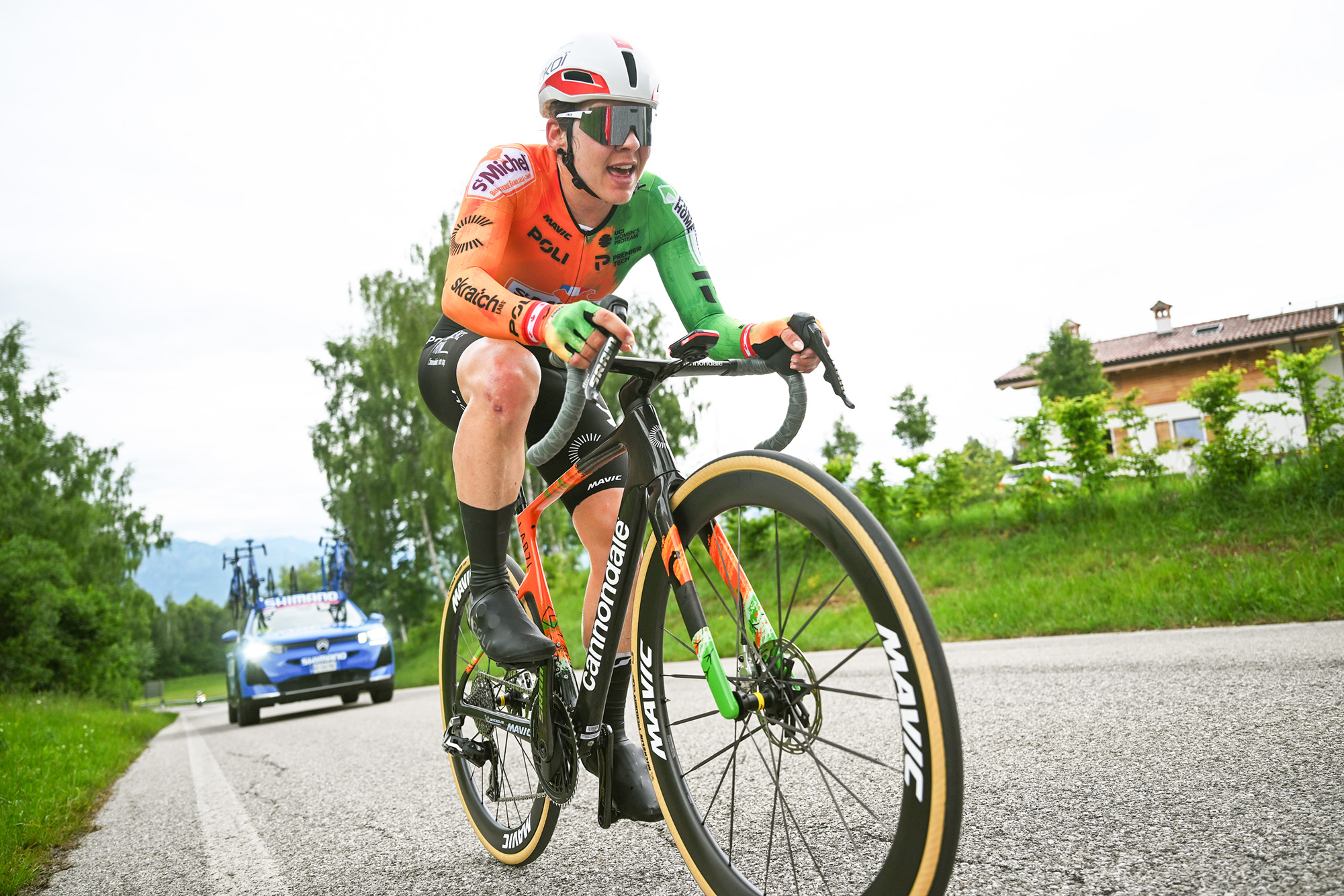 Alison Jackson riding alone ahead of a neutral support car during the Giro d'Italia