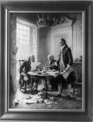 Benjamin Franklin reading draft of Declaration of Independence, John Adams seated, and Thomas Jefferson standing and holding feather pen and paper, around a table.