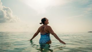 woman swimming at sunrise