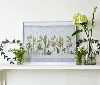 white wall with frame fresh flowers and farming pressed flowers