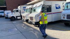 A postal worker walks to his truck in Queens, New York.