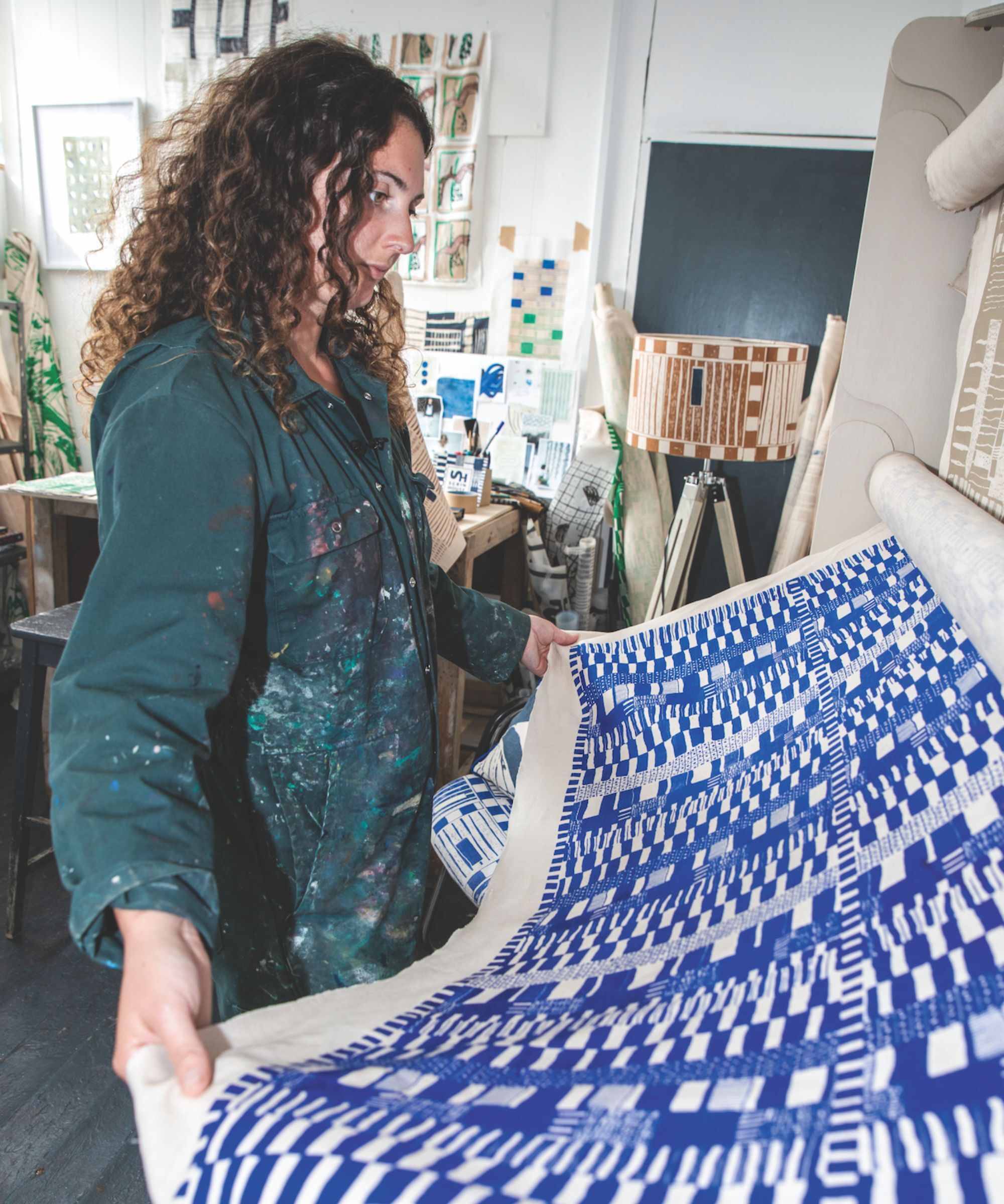 An artist rolling out her handprinted fabric