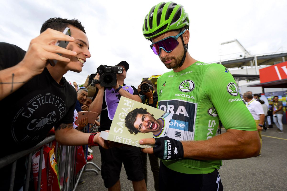 Peter Sagan signs autographs for the fans before stage 12