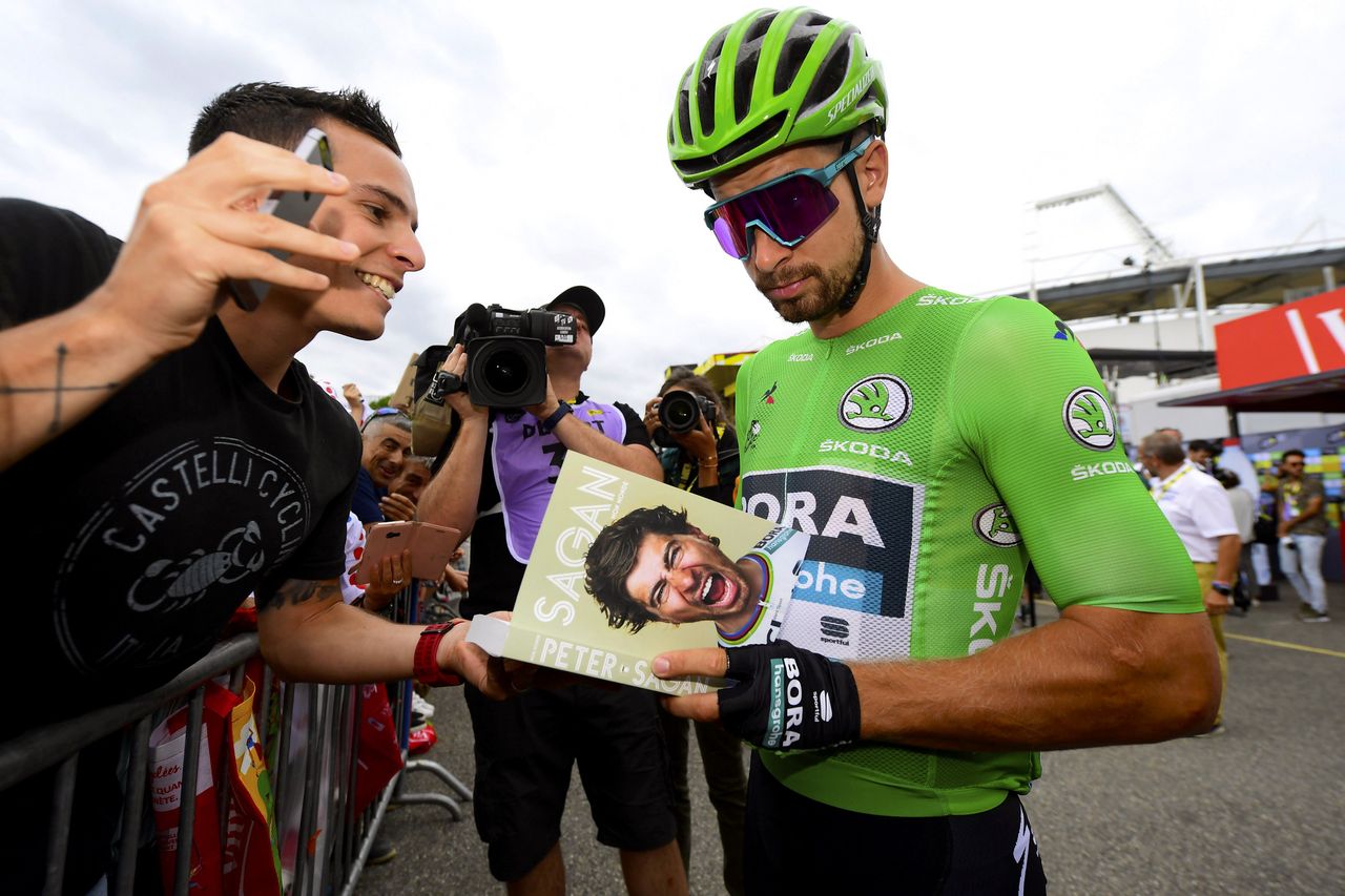 Peter Sagan signs autographs for the fans before stage 12