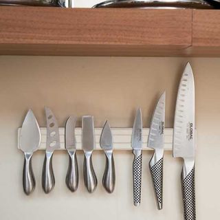 magnetic knife holder with knives on wall