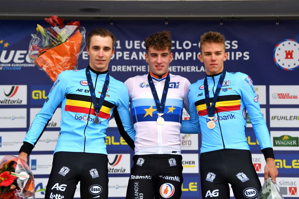COL DU VAM DRENTHE NETHERLANDS NOVEMBER 06 LR Silver medalist Niels Vandeputte of Belgium gold medalist Ryan Kamp of Netherlands and bronze medalist Thibau Nys of Belgium pose on the podium during the medal ceremony after the 19th UEC European Cyclocross Championships 2021 Mens U23 EuroCross21 UECcycling on November 06 2021 in Col du Vam Drenthe Netherlands Photo by Luc ClaessenGetty Images