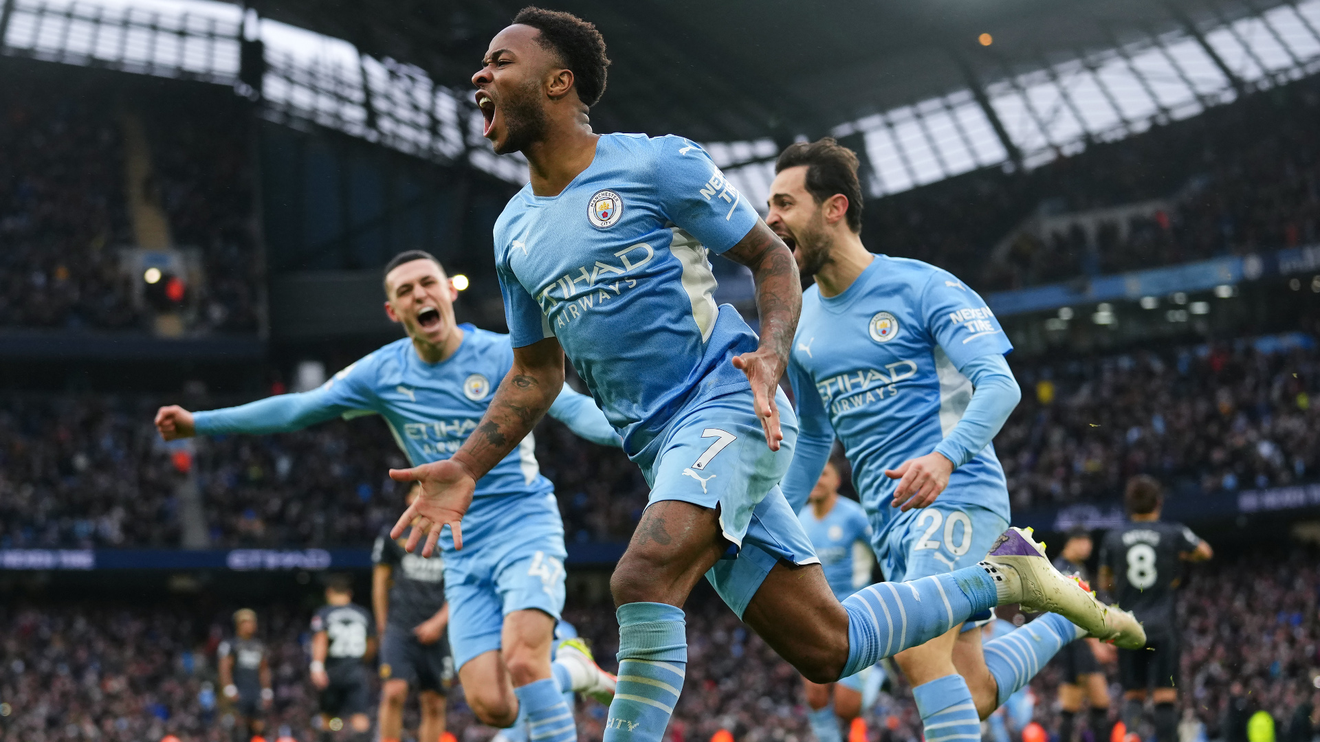 Raheem Sterling and the Manchester City players celebrate