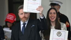 Political commentator Rogan O'Handley (C), aka DC Draino, US influencer Jessica Reed Kraus (L) and Chaya Raichik (R) carry binders bearing the seal of the US Justice Department reading "The Epstein Files: Phase 1" as they walk out of the West Wing of the White House in Washington, DC, on February 27, 2025. 