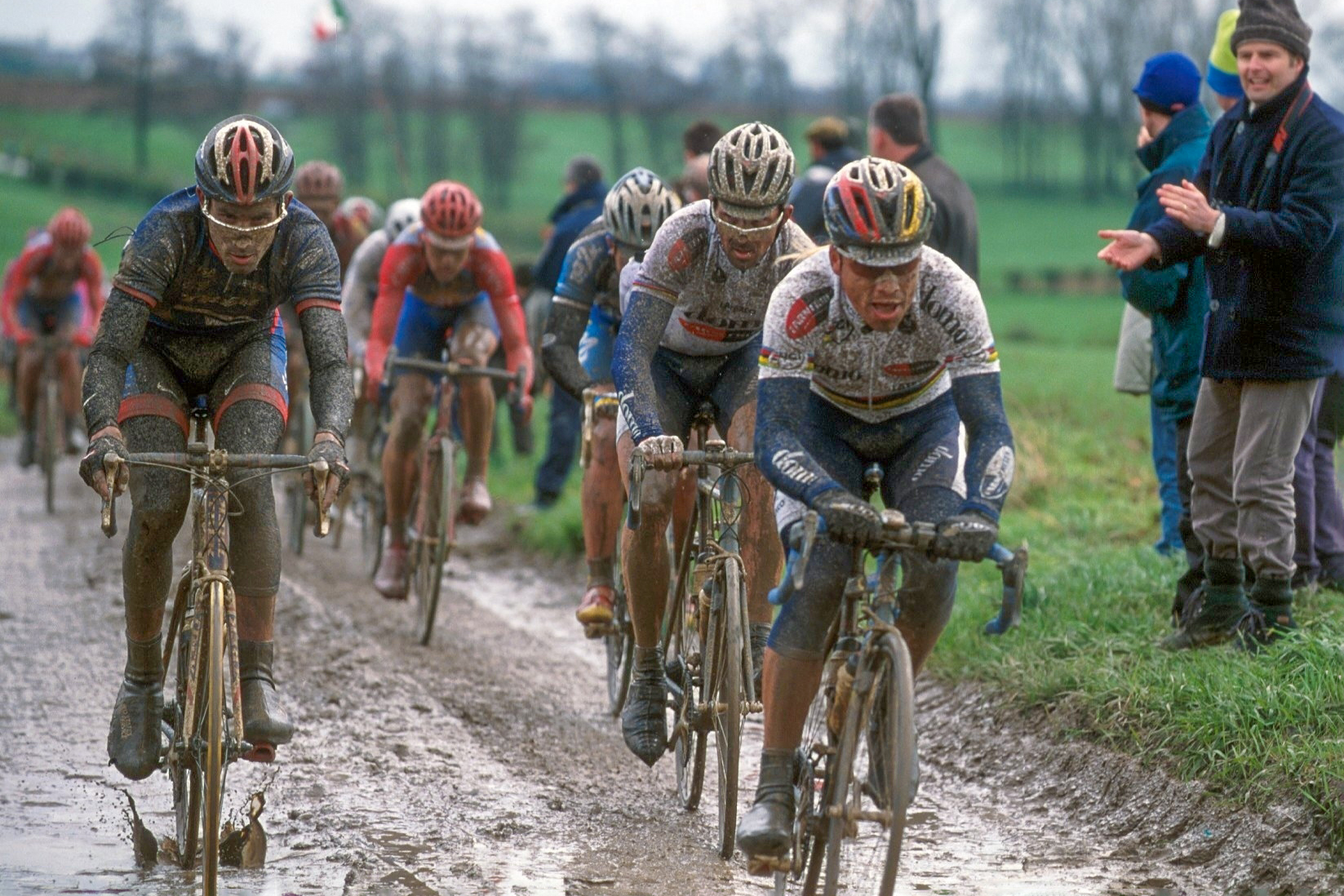 George Hincapie, Johan Museeuw, and Romans Vainsteins race through the mud at the 2001 Paris-Roubaix