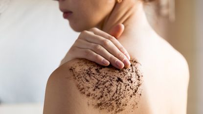 woman applying body scrub