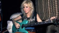 Portrait of American Rock musician Lita Ford as she poses with a guitar in her tour bus, Chicago, Illinois, September 30, 1984. 