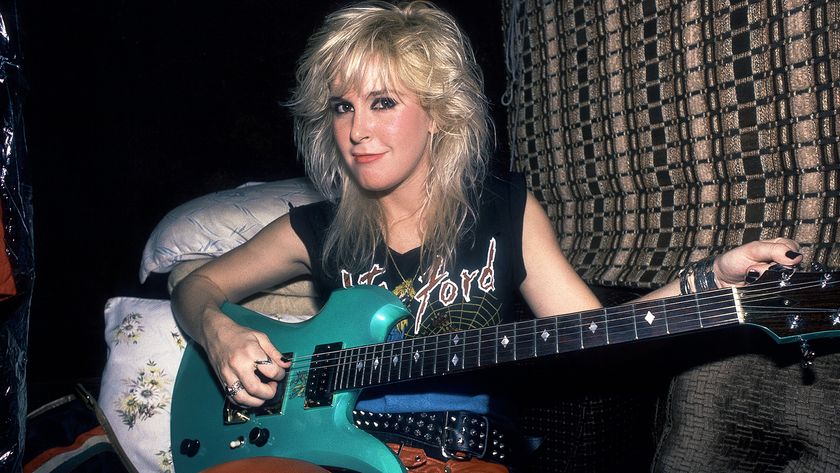 Portrait of American Rock musician Lita Ford as she poses with a guitar in her tour bus, Chicago, Illinois, September 30, 1984. 