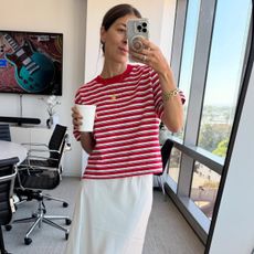 Woman in red t-shirt and white skirt