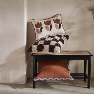 Tufted cushions stacked on top of bench