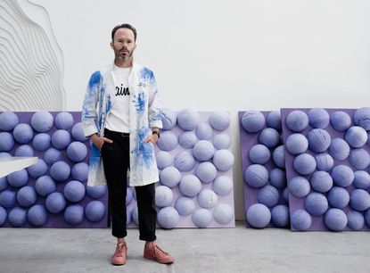 Man standing in front of wallpaper