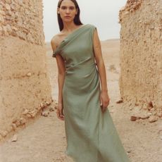 Model wearing sage green dress sold at Mango
