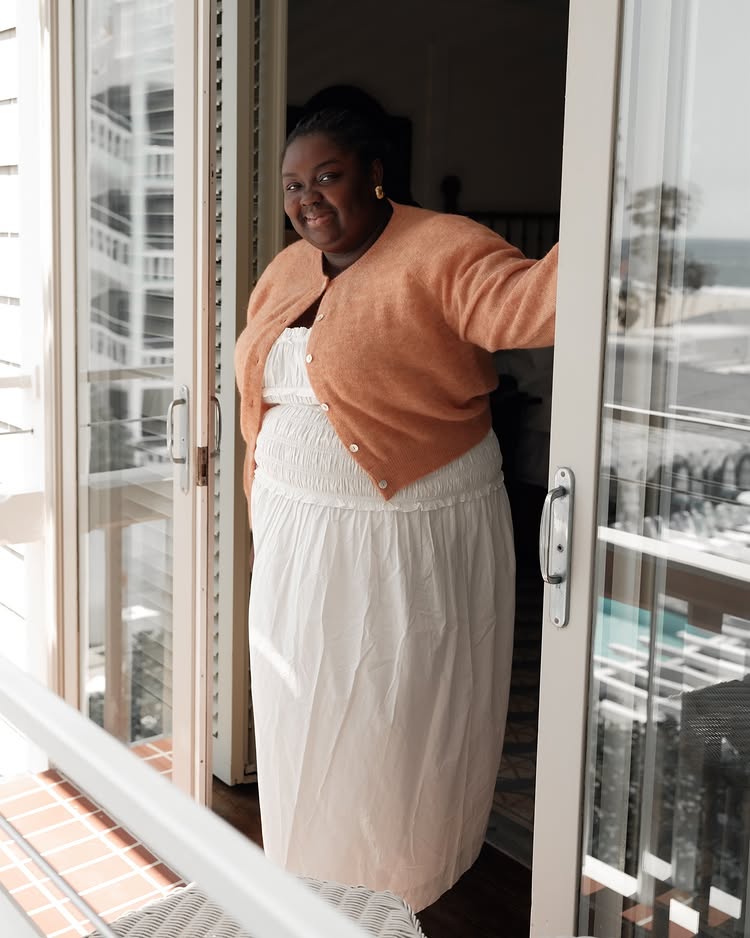 Summer Outfit Ideas 2025: @abimarvel wears a white dress with a coral cardigan
