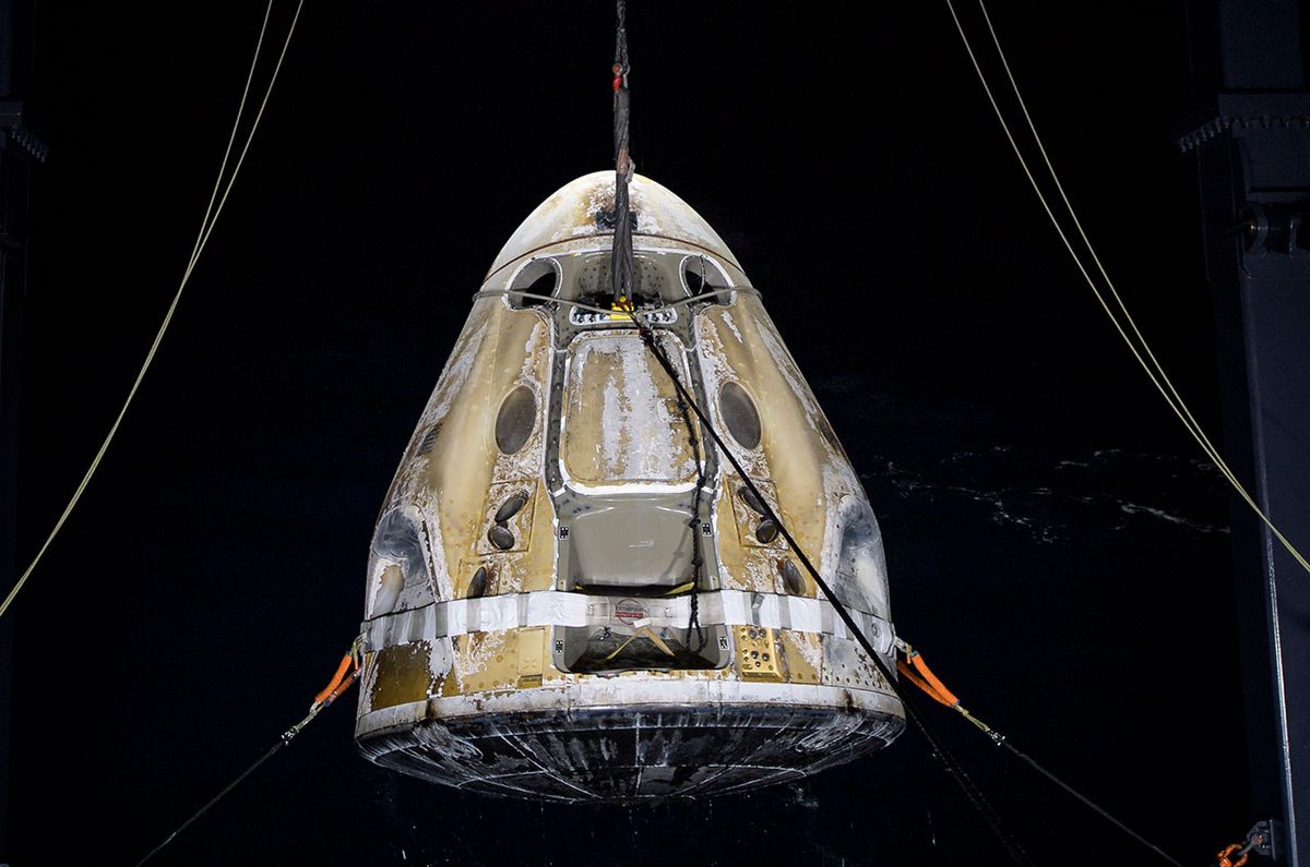 SpaceX’s Crew Dragon Resilience is lifted onto its recovery ship in the Gulf of Mexico, off the coast of Panama City, Florida on Sunday, May 2, 2021. The panels covering the capsule&#039;s parachutes were ejected in flight and splashed down separately.