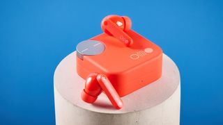 the nothing cmf buds pro 2 cmf by nothing buds pro 2 in bright orange shown in the smart dial charging case against a blue tom's guide background