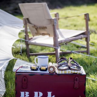tent with chair and sandles and mug